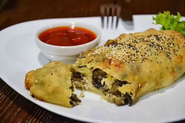 Close Up Food Photo of Savory Chicken Vegetable Cake with Sesame on White Plate