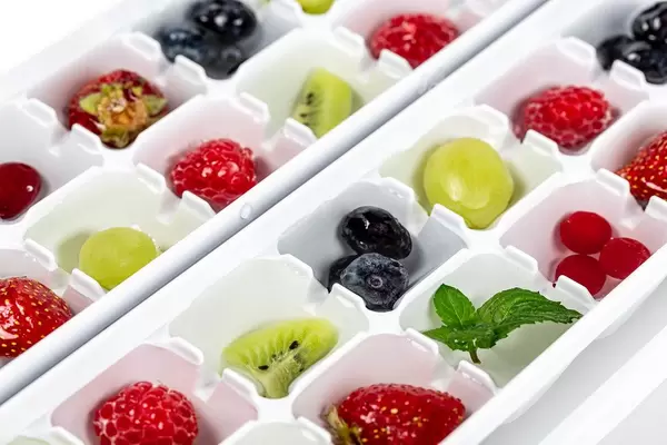 Close-up, fruits and berries in a form for freezing ice
