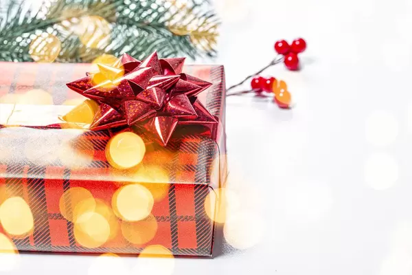 Close-up gift in red packaging with yellow bokeh. The concept of surprise for loved ones (Flip 2019)