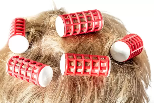 Close-up hair curlers on blond female hair