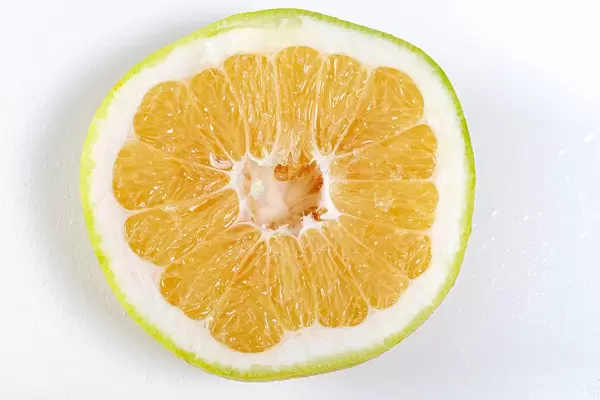 Close up half Citrus Sweetie (Oroblanco ) on white background (Flip 2019)