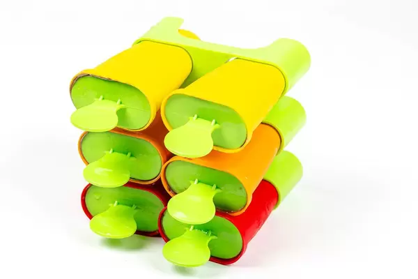 Close-up, ice cream maker form with sticks on white background