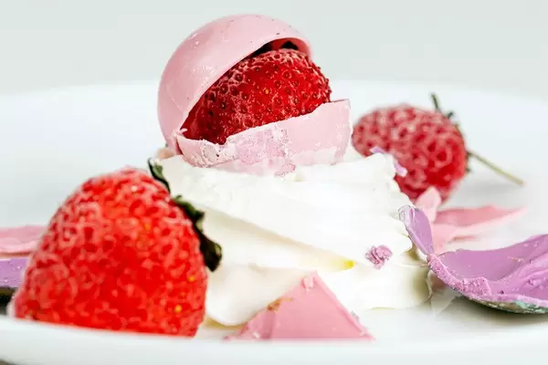 Close-up ice cream with strawberries and pink chocolate