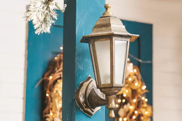 Close-up, lantern in front of the door with christmas wreath