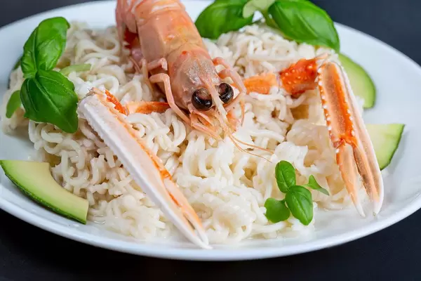 Close-up, lobster with noodles on a white plate