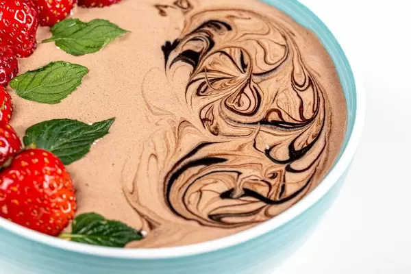 Close-up, oatmeal with fresh strawberries and chocolate yoghurt