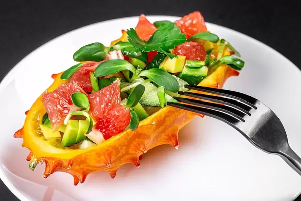 Close-up of a fresh vegetarian salad in half a kiwano (Flip 2020)