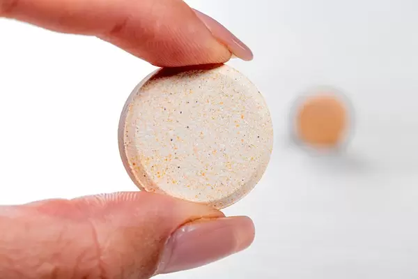 Close-up of a large brown tablet in a woman's hand