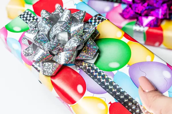 Close-up of a multicolored gift box in a woman's hand (Flip 2020)