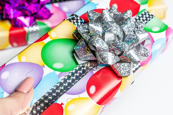Close-up of a multicolored gift box in a woman's hand
