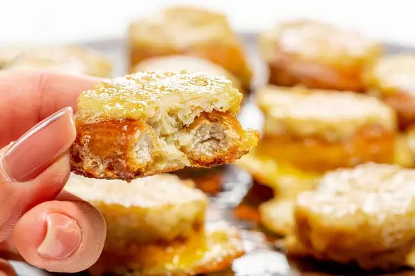 Close up of a piece of stuffed bun in a woman's hand