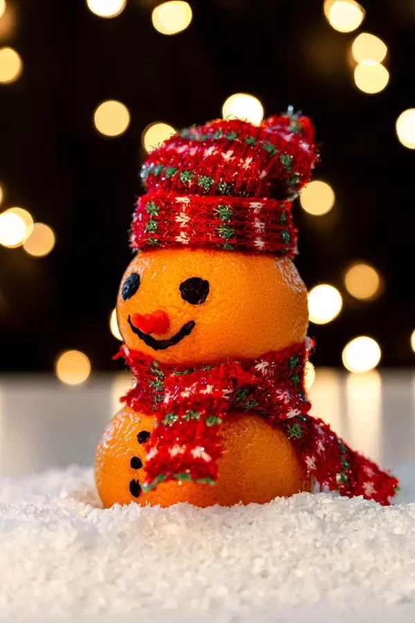 Close up of a snowman made of tangerines on the snow (Flip 2019)