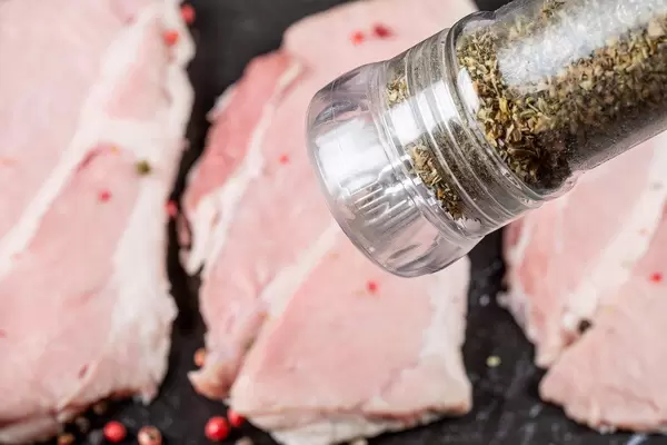 Close- up of a spice mill over steaks (Flip 2020)