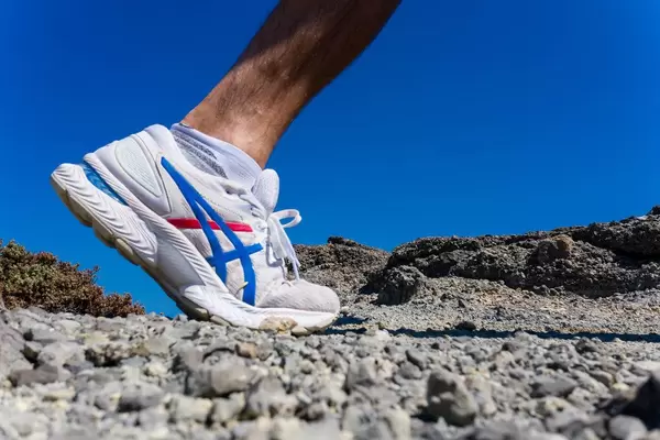 Close-up of an Asics running shoe for men. Active holiday in Greece, running on stones