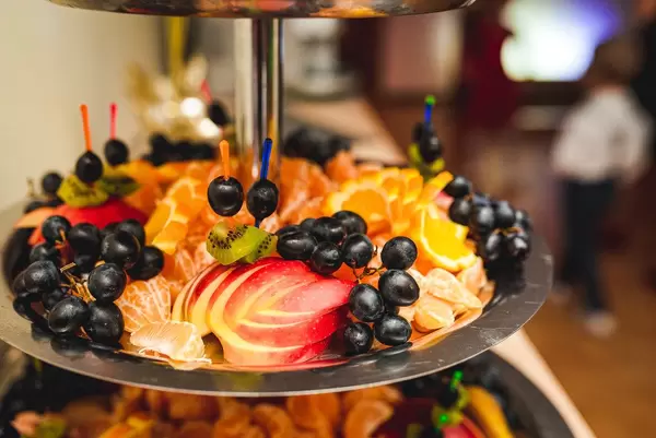 Close Up Of Aples, Black Grapes, Tangerines, Oranges