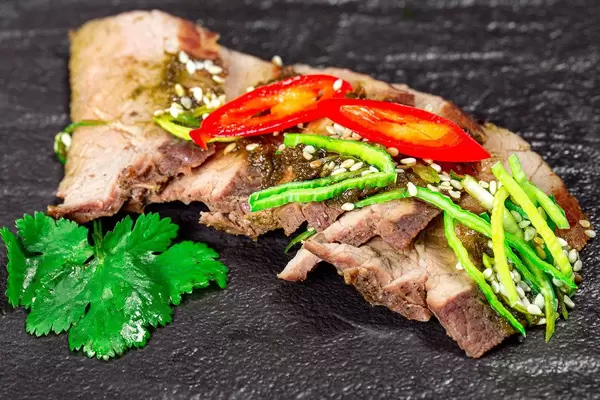 Close-up of baked beef with leek and hot chili pepper (Flip 2020)