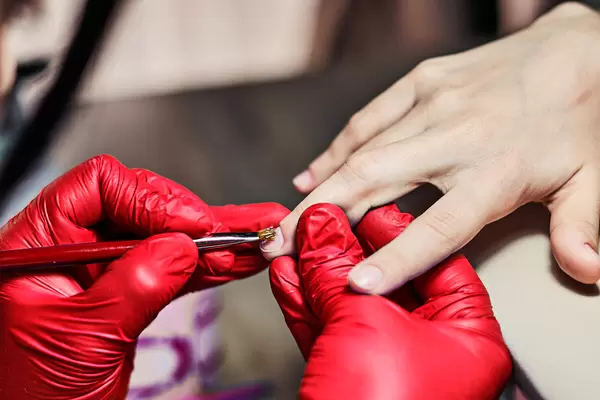 Close-up of beautiful woman hands getting manicure in spa salon
