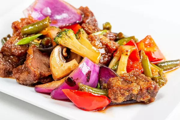 Close-up of beef baked with vegetables and mushrooms