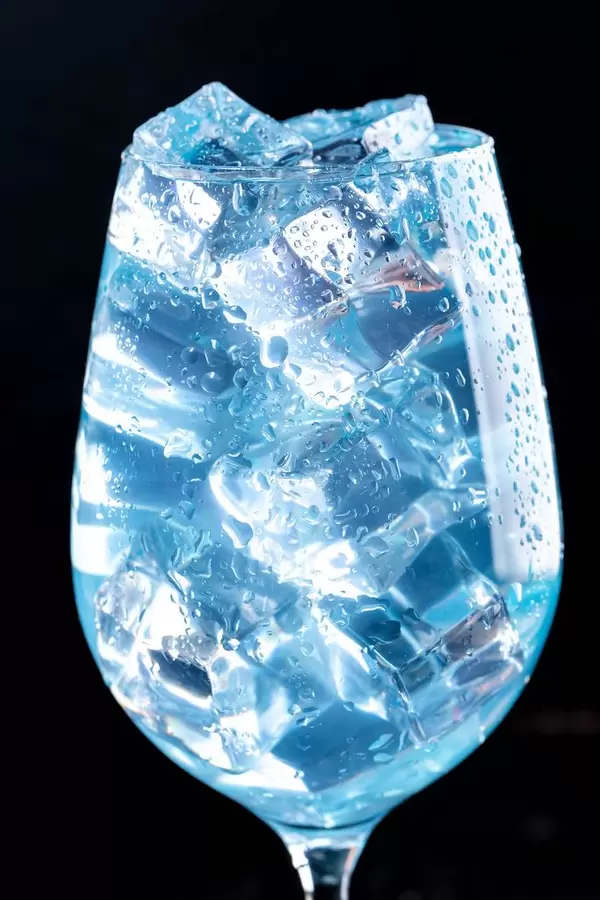 Close-up of blue cocktail with ice cubes in the glass (Flip 2019)