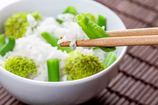 Close up of boiled rice with asparagus and broccoli in a white bowl (Flip 2019)
