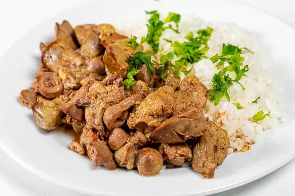 Close up of braised chicken liver with hearts and boiled rice (Flip 2019)