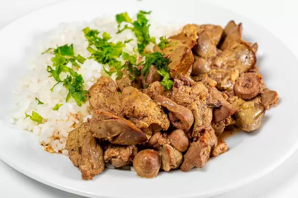 Close up of braised chicken liver with hearts and boiled rice