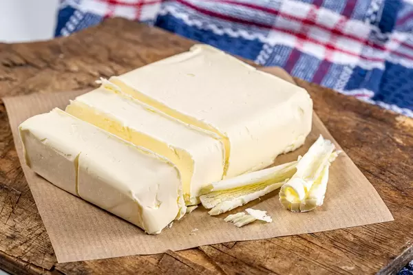 Close-up of butter on an old kitchen Board