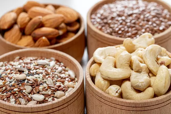 Close-up of cashew nuts, almonds and various seeds in wooden bowls (Flip 2019)
