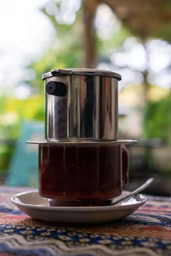 Close Up of Ceramic Cup with Vietnamese Coffee Filter on Top