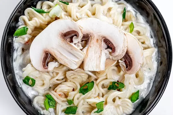 Close-up of cheese and mushroom soup with pasta