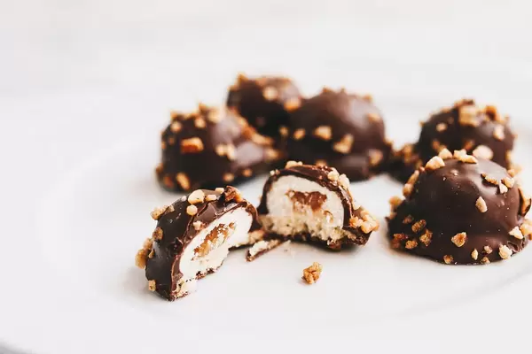 Close up of chocolate candy cutted in two. White background