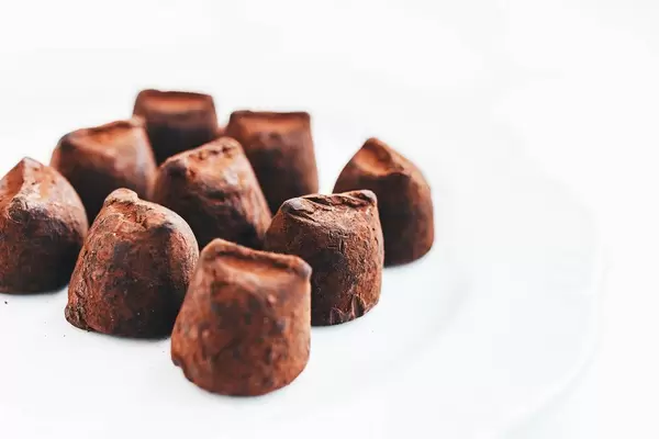 Close up of chocolate truffles on white background