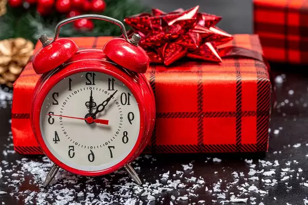 Close up of Christmas background with red alarm clock and gift boxes (Flip 2019)