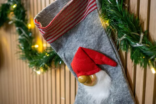Close Up of Christmas Elf on Stocking with String Lights and Artificial Garland as Christmas Decoration in a Cafe