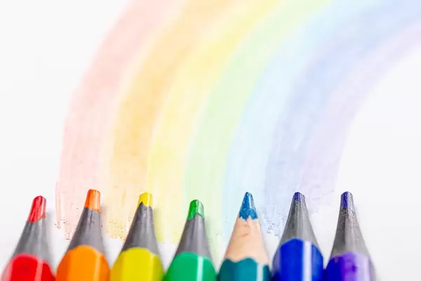 Close-up of colored pencils and a painted rainbow on a white background (Flip 2019)