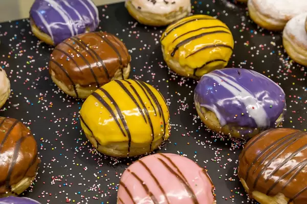 Close-up of colourful doughnuts with bright icing and sprinkles