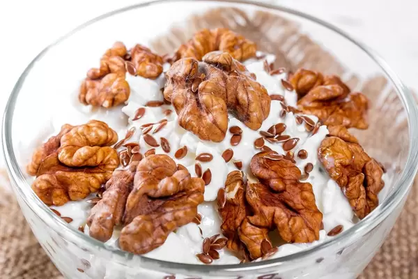 Close-up of cottage cheese dessert with walnuts and flax seeds