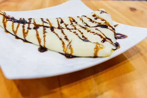 Close up of crepe with chocolate syrup