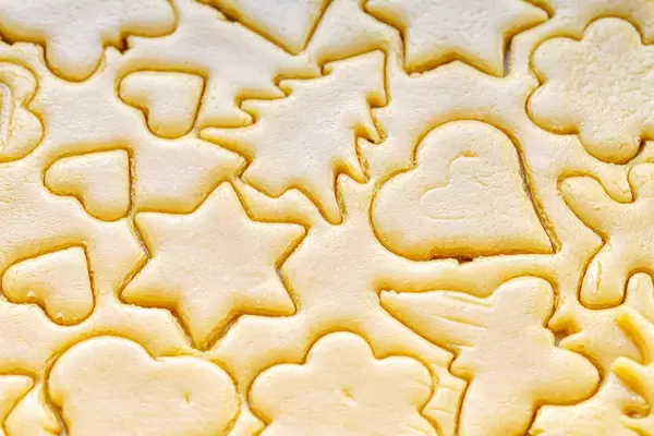 Close-up of cut different shapes of cookies in raw dough (Flip 2019) (Flip 2019)