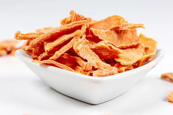 Close- up of dried pumpkin slices in a white bowl