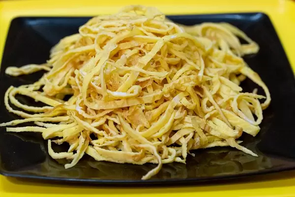 Close up of egg omelette cut into strips