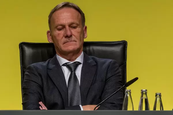 Close-up of executive Director of german soccer team BVB, Hans-Joachim Watzke, with crossed arms at annual general meeting