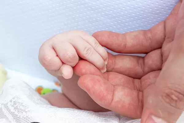 Close up of father hand and little hand his daughter