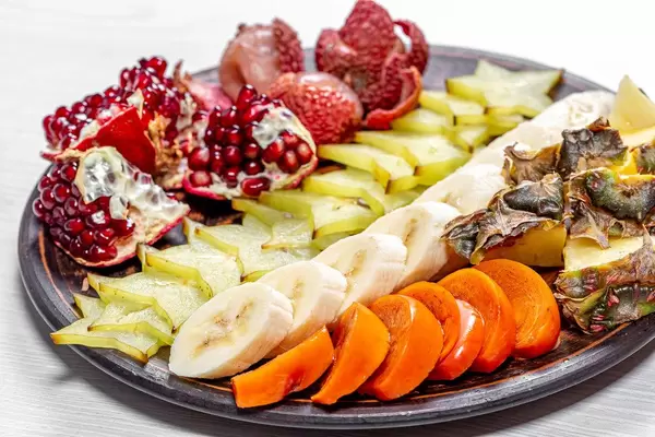 Close up of fresh exotic fruit slices on a plate
