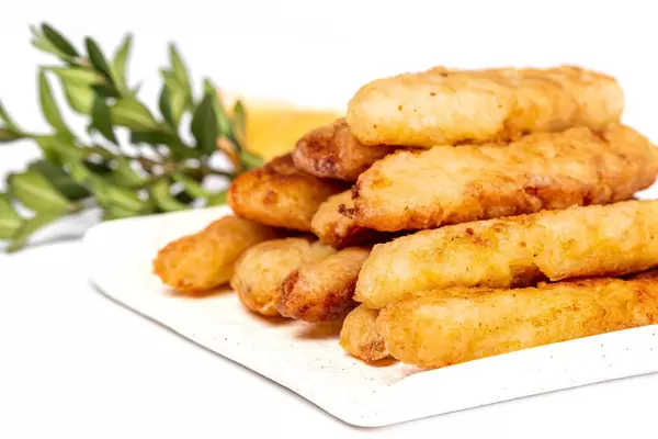 Close-up of fried fish sticks in crispy breading