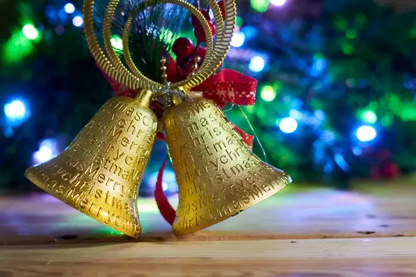 Close up of golden Christmas ornament against Xmas tree