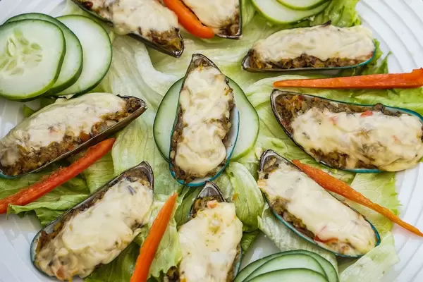Close up of green shell mussels in cream cheese