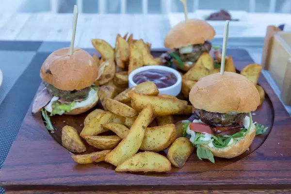 Close-up of hamburgers and roast potatoes at Aelia Restaurant Kassandra