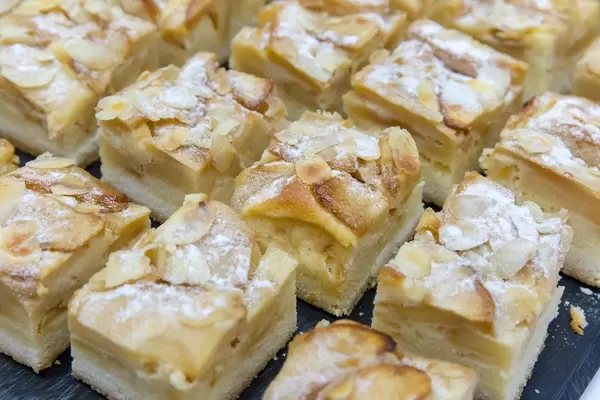 Close-up of healthy apple-almond pie on black tray at the BarCamp in Bonn