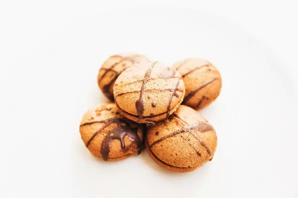 Close up of honey cookies with chocolate on white background